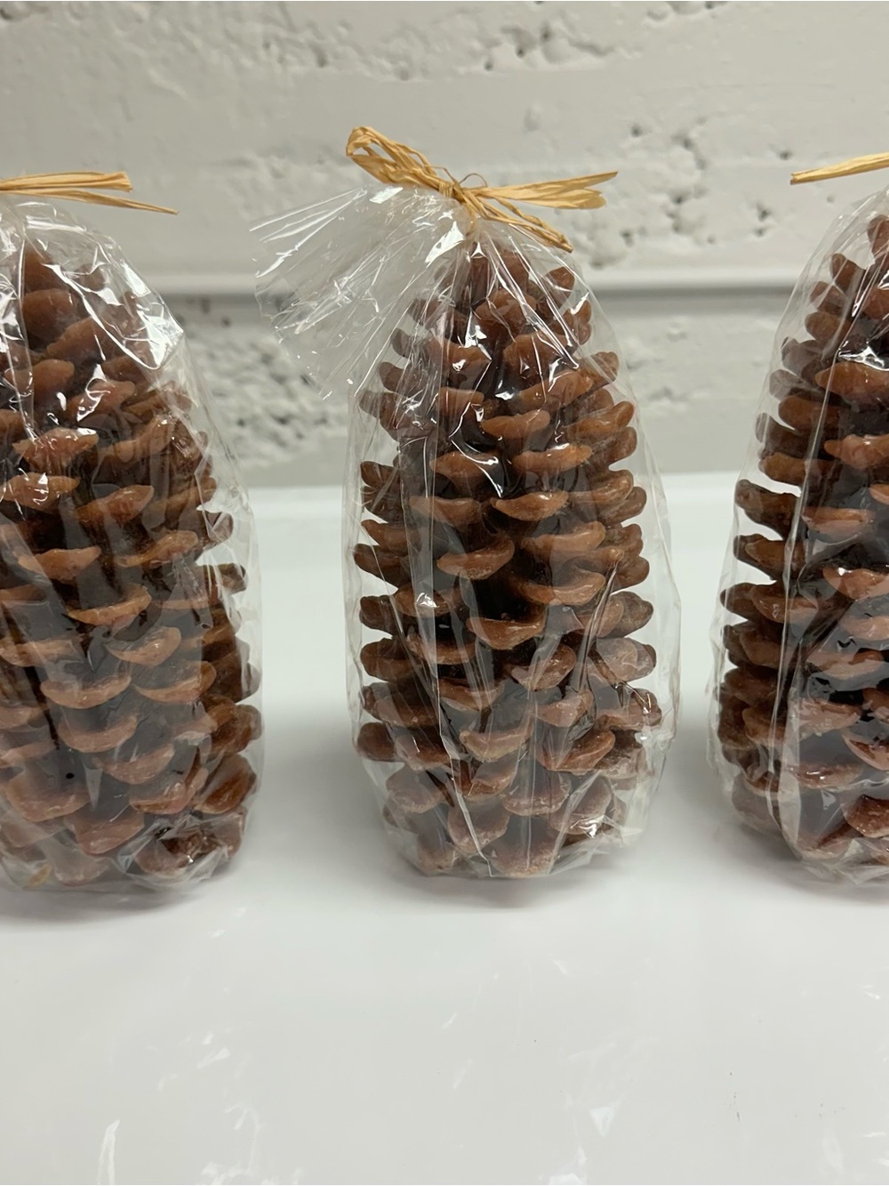 NWT set of three pinecone candles. Approx. 9” tall.